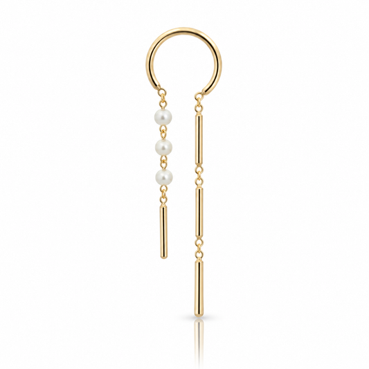 Mismatched 14k yellow gold chime earrings by JACK & G featuring delicate white pearls, slender articulated gold drops, and small hoop closures.