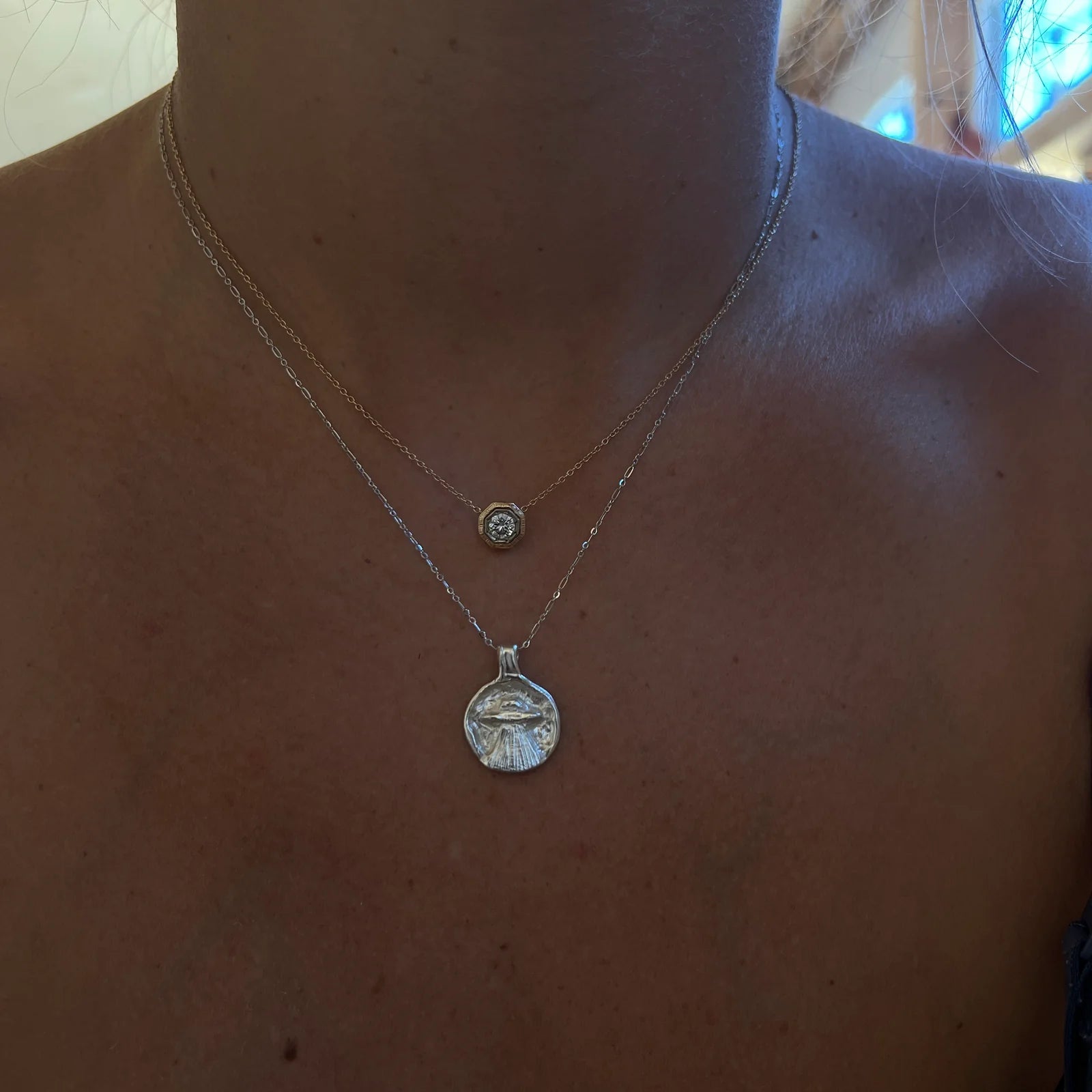 Model wearing the gold vermeil Goin’ Home UFO pendant necklace layered with a shorter chain.