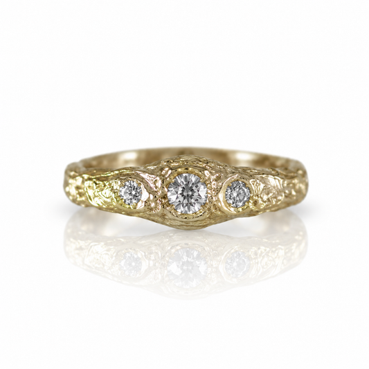 Monolithic Three Stone Diamond Ring in recycled 14k yellow gold featuring three natural old mine cut diamonds totaling 0.33 carats and hand-carved geological texture.