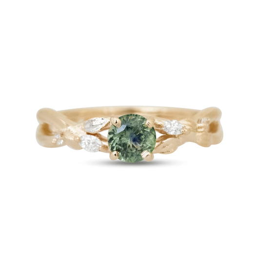 Handcrafted 14k yellow gold branch engagement ring with green Montana sapphire, diamond accents and organic detailing.