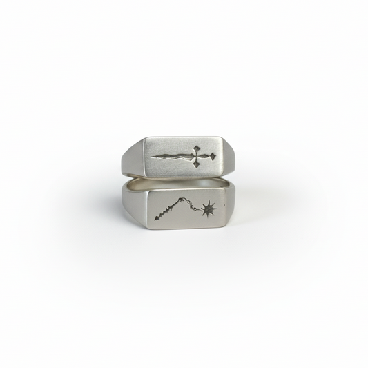 Choose Your Weapon sterling silver signet rings by Morgaine Faye, featuring engraved medieval dagger and chain morningstar designs.