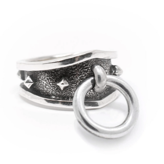 Palisades Ring by Morgaine Faye in oxidized sterling silver, featuring a wide textured sculptural band and a free-hanging kinetic ring.