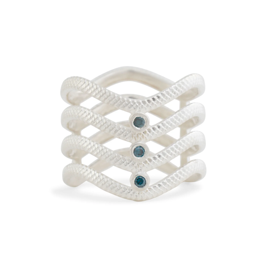Michaela Farkasovska Ocean Waves Diamond Ring handcrafted in sterling silver with four sculptural wave bands, textured detailing, and a teal diamond accent.