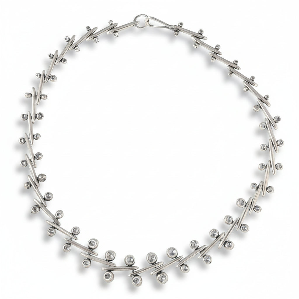 Full view of the Ocotillo Collar Necklace showing its circular arrangement of hand-fabricated sterling silver links and oxidized finish.