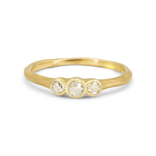 18k yellow gold three-stone ring by Erin Cuff featuring three reclaimed white diamonds totaling 0.22 carats in a smooth matte gold band.