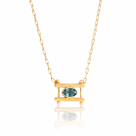 Oval Kiyo Necklace by M. Hisae featuring a light blue Montana sapphire set horizontally in solid 14k yellow gold on a delicate gold chain.
