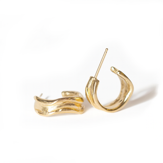 Fluvial Hoops by Oxbow in 14k yellow gold vermeil, featuring sculptural hoop shapes with flowing, organic curves inspired by river forms.