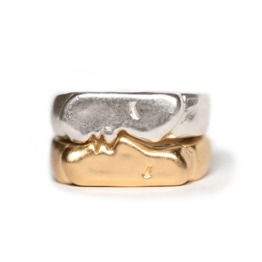Kiss Signets Pair by Oxbow, featuring two interlocking sculptural rings in sterling silver and 14k gold vermeil with a matching kiss motif.
