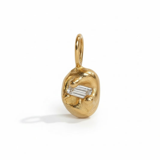 Ore Charm by Oxbow in solid 14k yellow gold, featuring an organic sculptural shape with a baguette diamond and gold bail.
