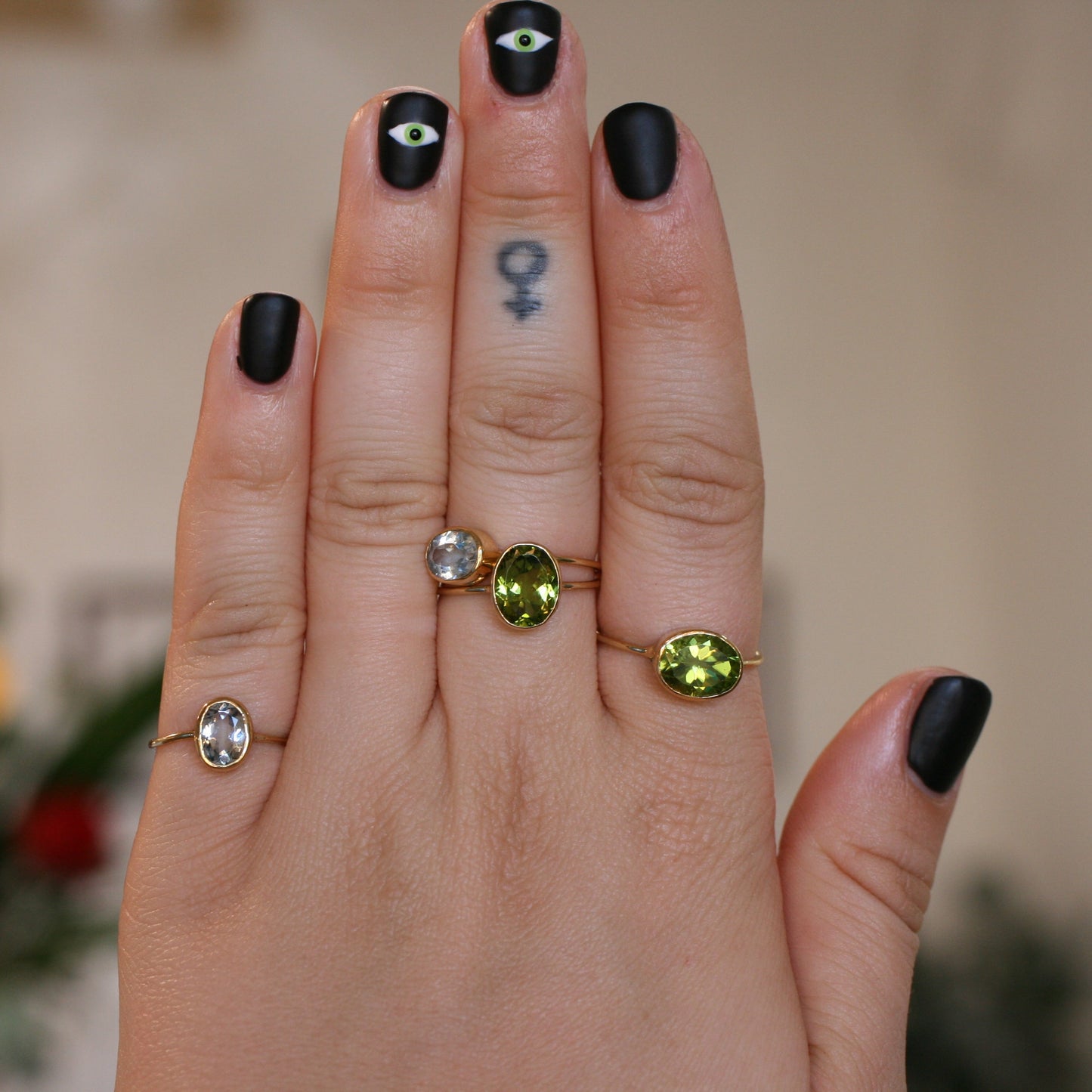 18k yellow gold vertical-set peridot ring worn on hand for scale and everyday style.