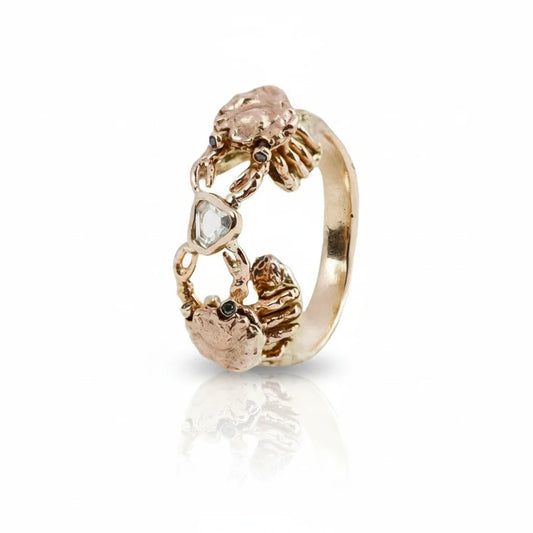 Petite Crab Ring in 14k yellow, rose, and white gold, featuring two hand-carved crabs with black diamond eyes and a bezel-set rose-cut diamond.