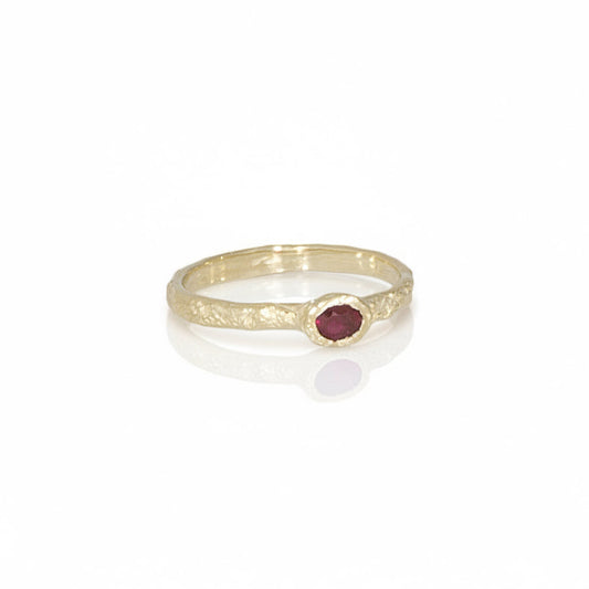 Petite Ruby Petra Ring in recycled 14k yellow gold featuring a natural ruby set into a hand-carved, rock-textured band.