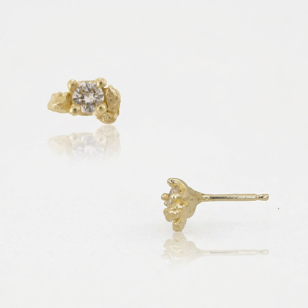 Side view of Petra Diamond Prong Stud Earrings by Alexis Pavlantos, showing natural round brilliant-cut diamonds, sculptural 14k yellow gold prong settings, and delicate gold posts.