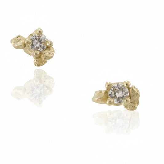 Pair of Petra Diamond Prong Stud Earrings in solid 14k yellow gold featuring round brilliant-cut diamonds in hand-carved, organic rock-textured settings.