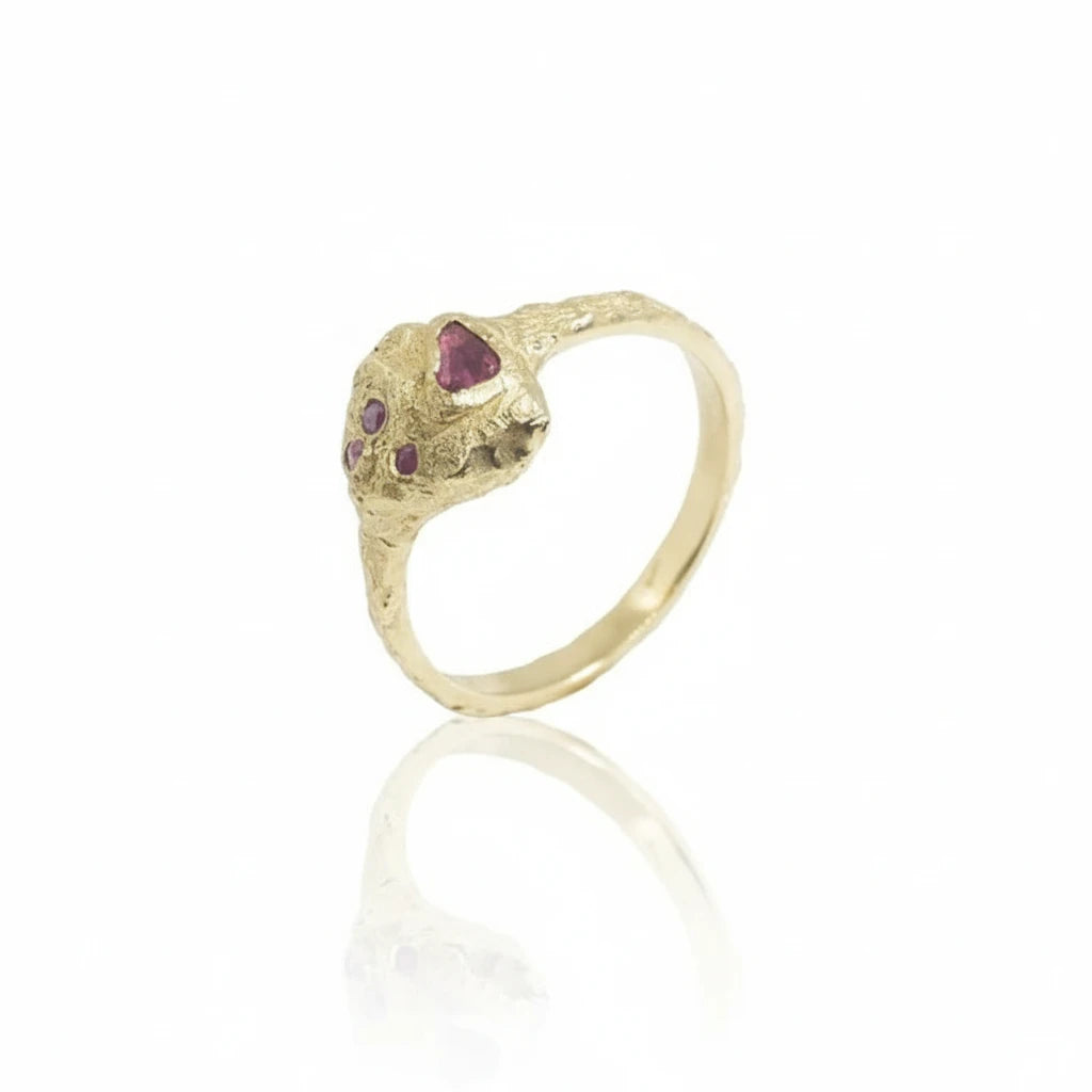 Petra Ruby Ring in recycled 14k yellow gold, featuring four natural rubies totaling 0.25 carats set into a hand-carved, rock-textured design.