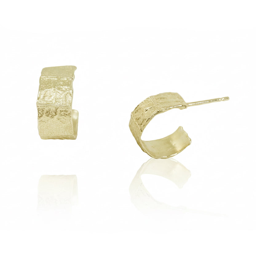 Philo Hoop Hug Earrings in solid 14k yellow gold by Alexis Pavlantos, showcasing organic leaf-inspired textures, a sculptural curved shape, and gold posts.