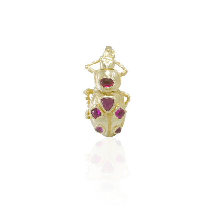 Front view of the Pinacate Beetle Ring with ruby cabochons, highlighting the intricate beetle head, textured gold details, and sculptural construction.