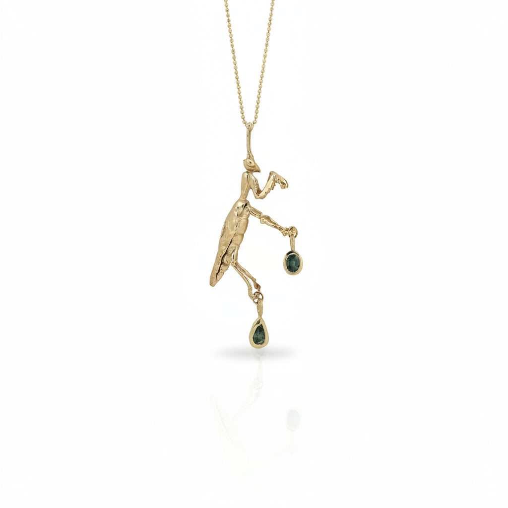 Praying Mantis Necklace in solid 14k yellow gold featuring a hand-carved mantis pendant with two natural sapphires suspended from a delicate gold chain.