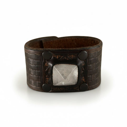 Handmade pyramid quartz leather cuff bracelet by Kelly Horrigan featuring a geometric quartz stone centerpiece, dark brown textured leather, and black metal accents.