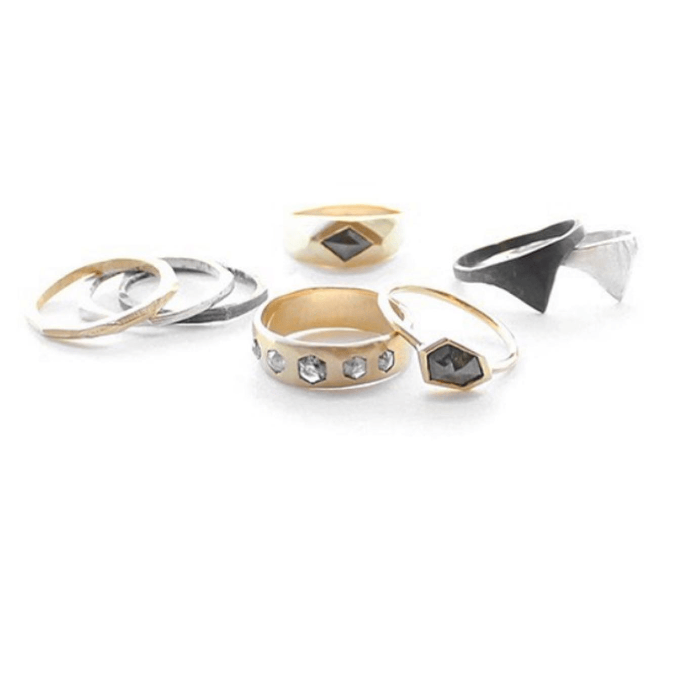 Assorted gold rings displayed together, including the Quintet Ring with hexagon diamonds.