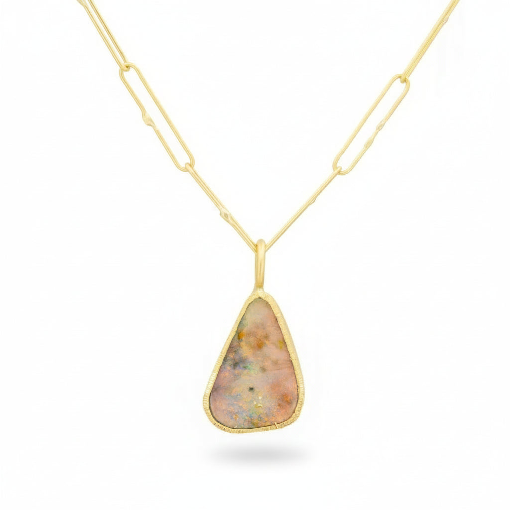 Rainbow Opal 18k gold pendant shown on a gold chain with hand-engraved bezel detail.
