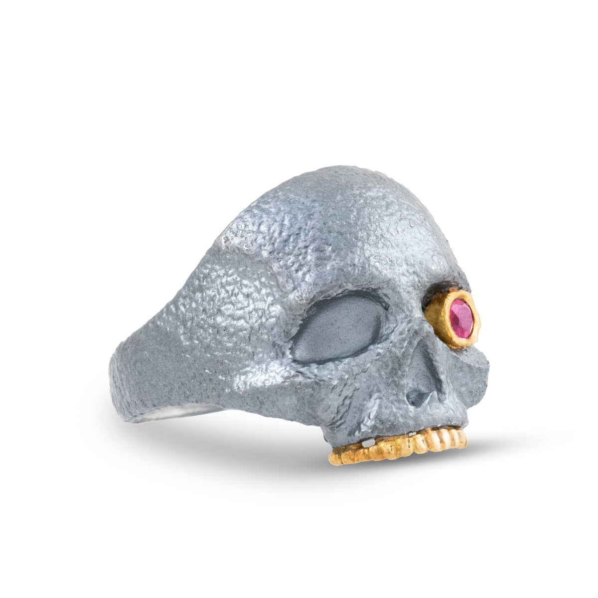 Side profile of The Masque of the Red Death Skull Ring showing its sculptural sterling silver skull, ruby eye, and gold teeth details.