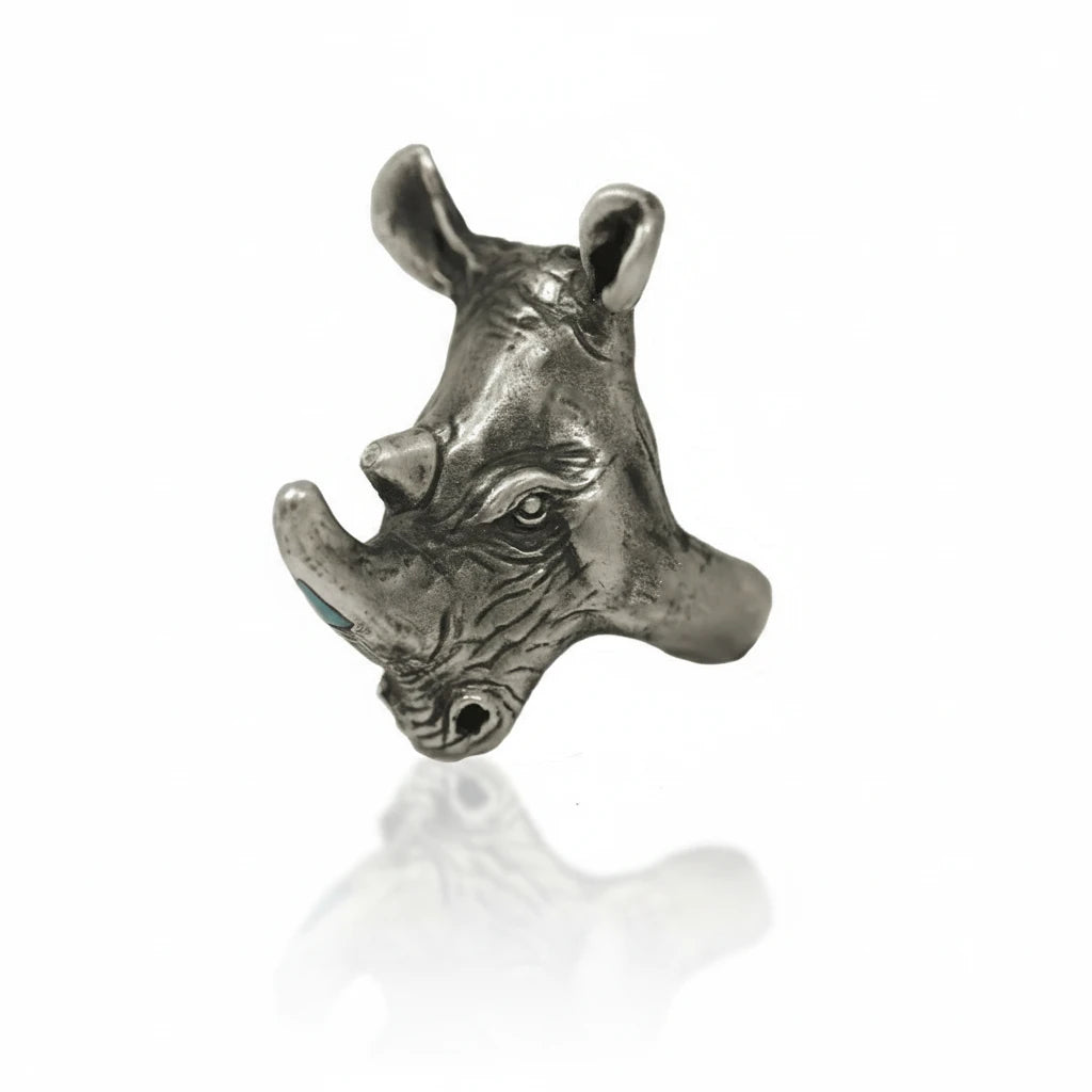 Angled view of the handcrafted sterling silver Rhino Ring by Alexis Pavlantos, highlighting the detailed rhinoceros sculpture, textured surface, and raised horns.