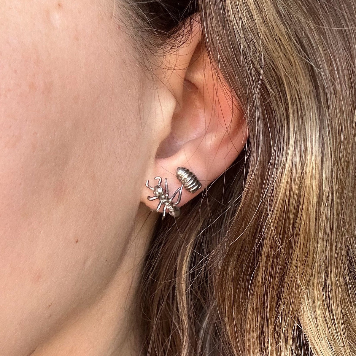 Model wearing sterling silver Roly Poly Stud Earrings, showcasing their petite 8mm size and organic insect-inspired design.