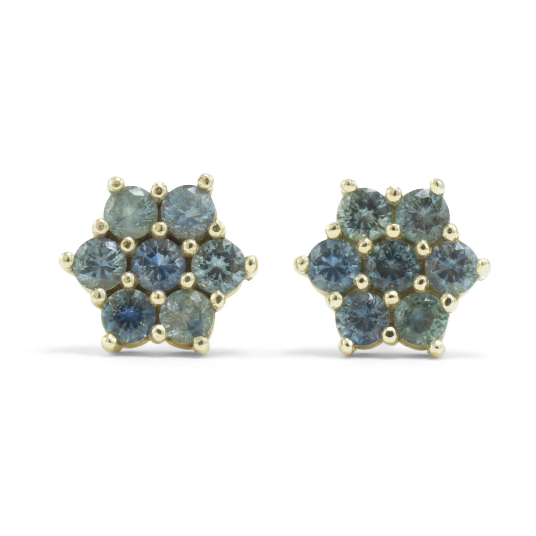 Pair of 14k gold rose stud earrings set with Montana sapphires on a white background.