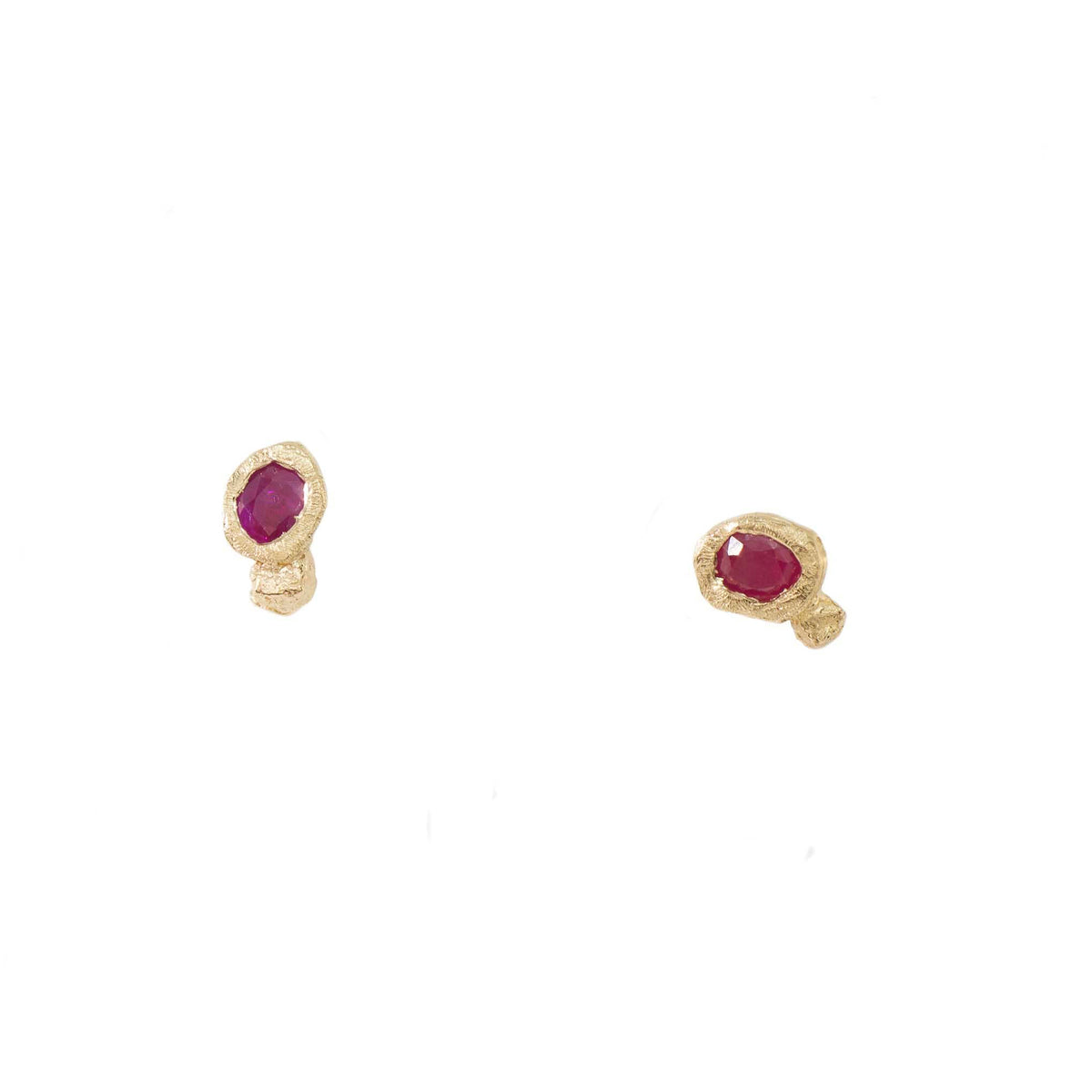 Front view of a pair of Ruby Petra Stud Earrings by Alexis Pavlantos, featuring natural red rubies in organic, hand-carved 14k yellow gold settings.