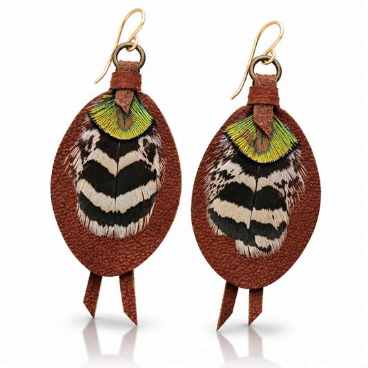 Handmade russet brown leather earrings by Kelly Horrigan featuring black-and-cream patterned natural feathers, iridescent green accents, and 14k gold-filled hooks.