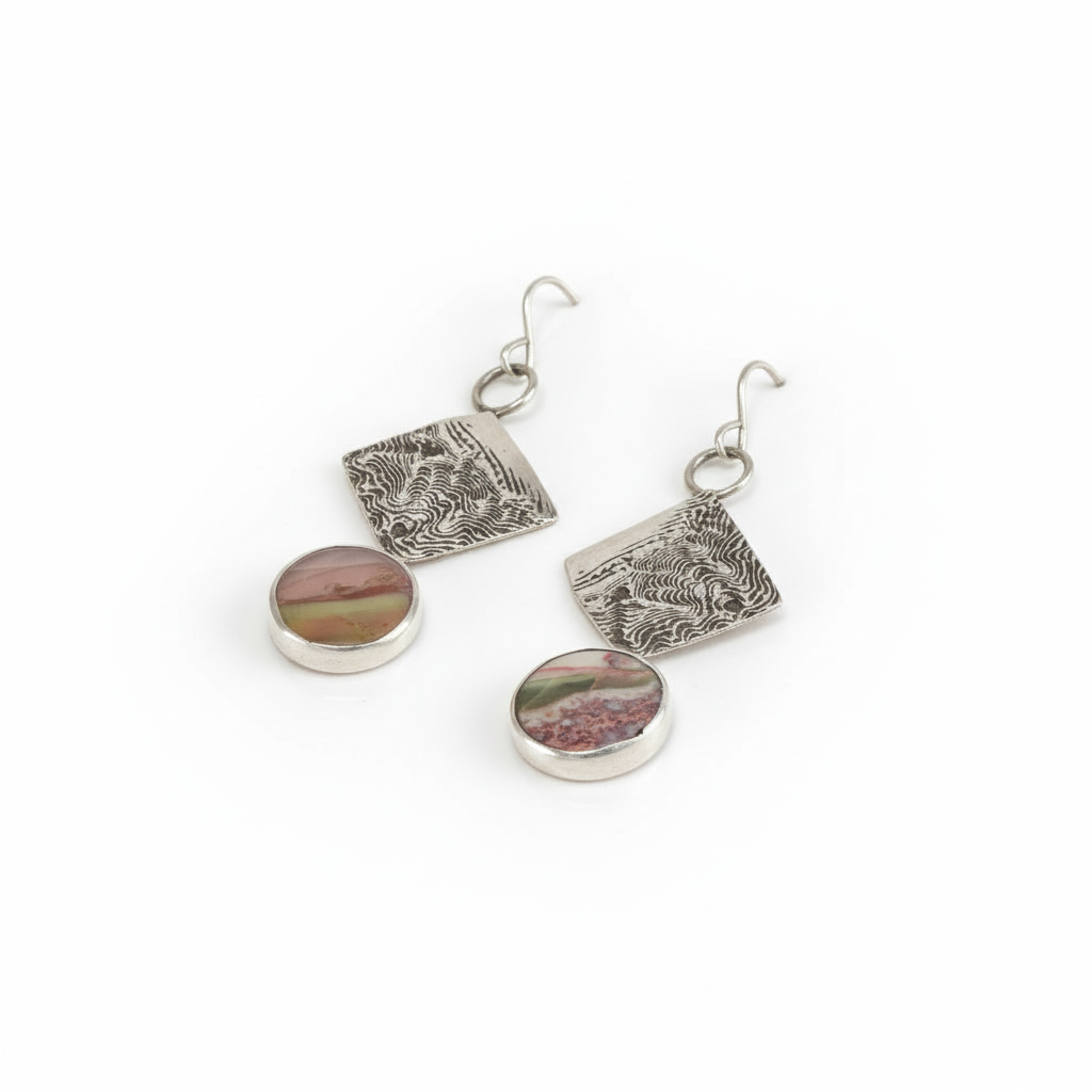 Side-angle view of Sandia Agate Inlay dangle earrings showing the textured silver and agate inlay details.