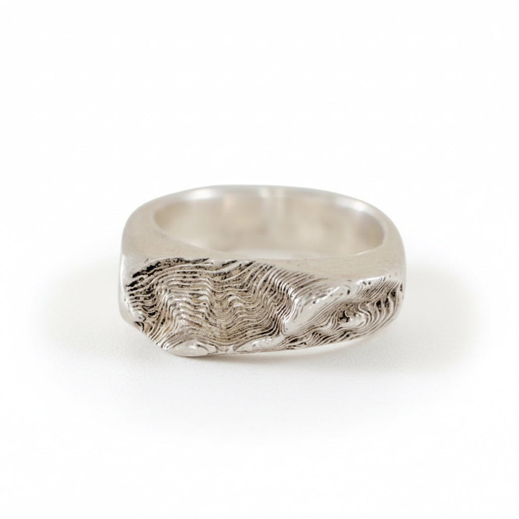 Side view of the Sandia Crest topo inlay ring showing crushed turquoise and carved mountain texture.