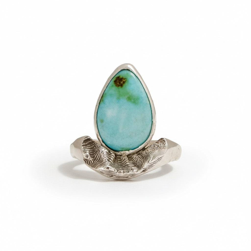 Sterling silver Sandia Hug ring with turquoise cabochon and sculpted mountain-inspired design.