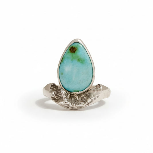 Sterling silver Sandia Hug ring with turquoise cabochon and sculpted mountain-inspired design.