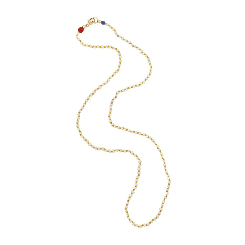 Full-length seed pearl necklace knotted on yellow silk with small colorful accent beads.