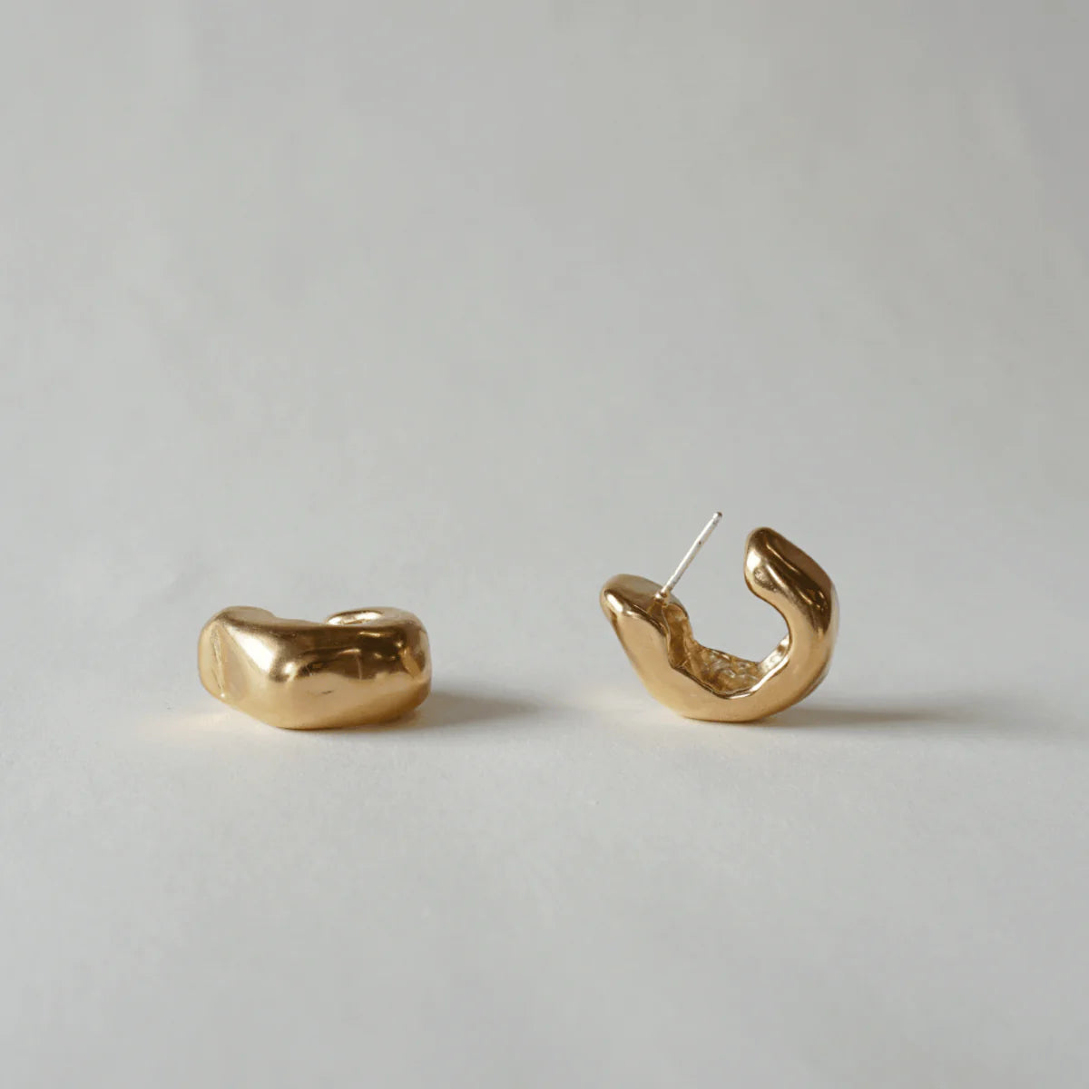 Pair of Serrano Hoops in 14k gold displayed together on a neutral background.
