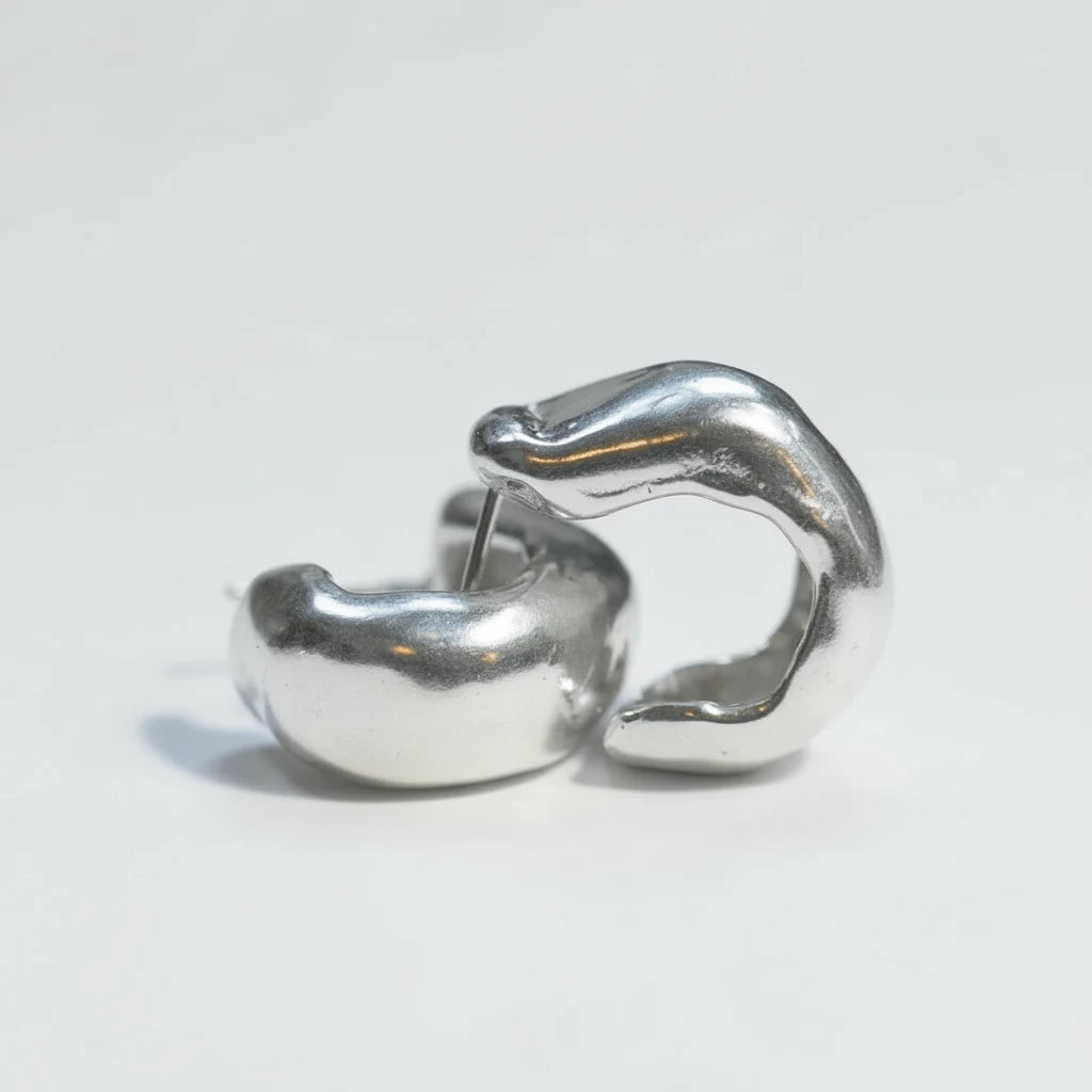Pair of Serrano Hoops in sterling silver, sculptural organic hoop earrings.
