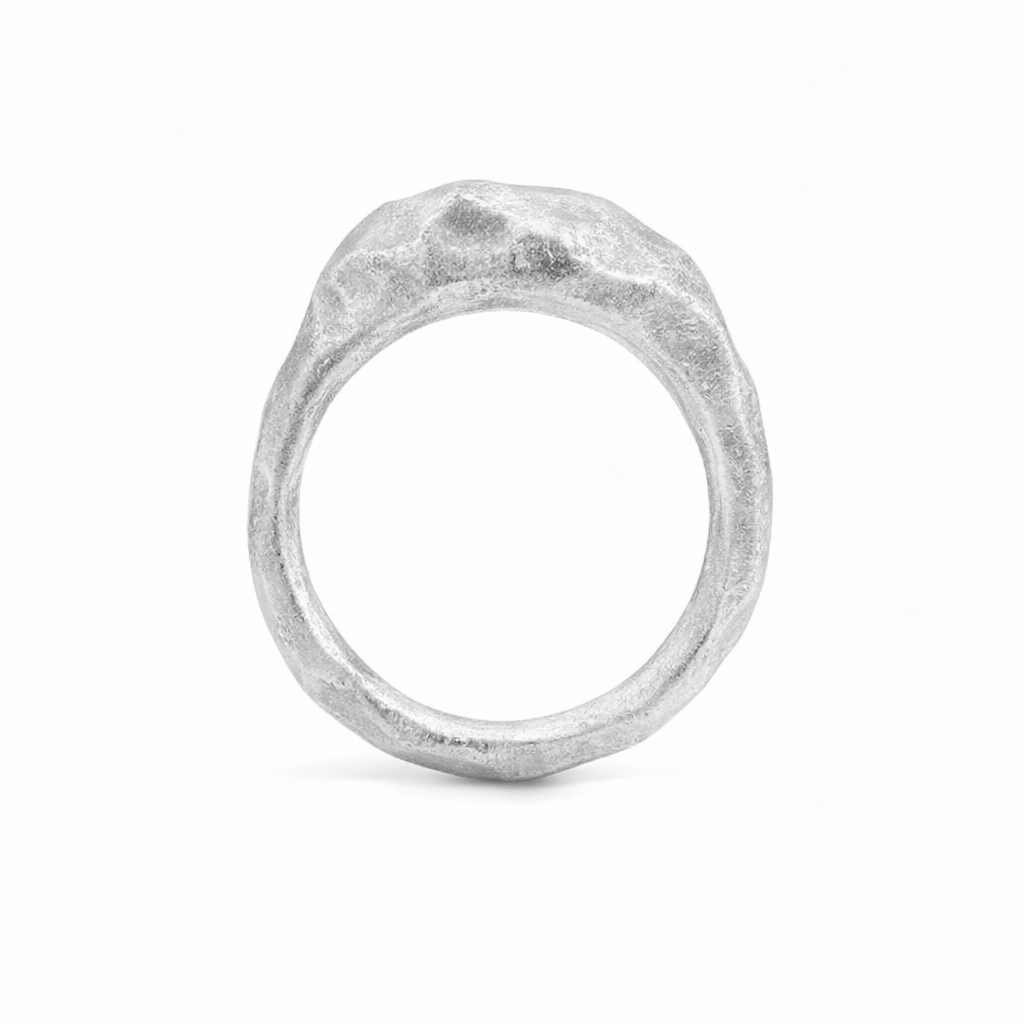 Top view of Shaya Durbin's Carved Elevated Stacker ring showing its irregular circular silhouette, sculptural carved texture and bright sterling silver finish.