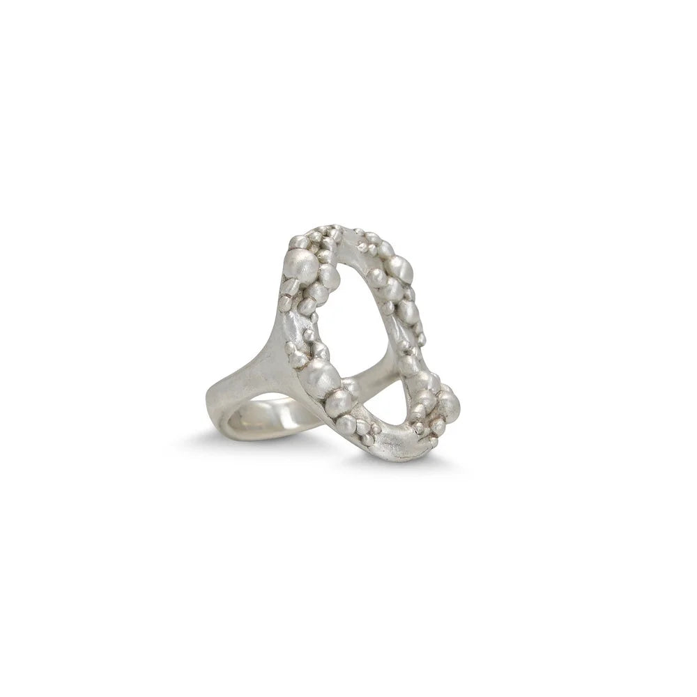 Angled view of Shaya Durbin's sterling silver Cluster Circle Ring showing the open circular structure and organically arranged polished silver clusters.