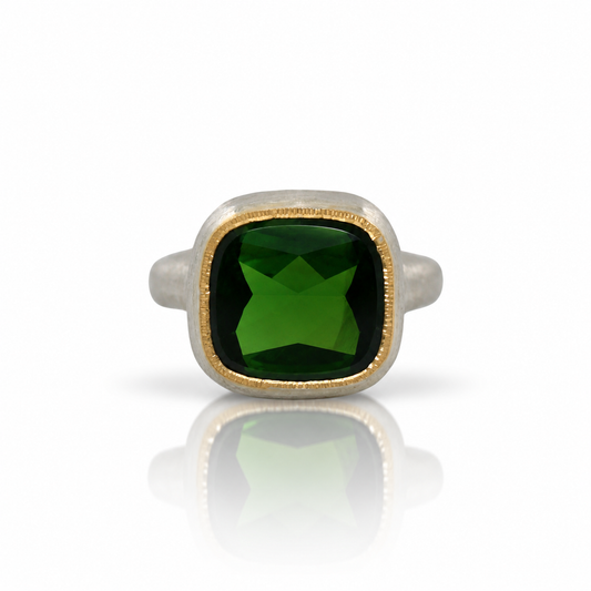 Side view of Shaya Durbin's Cushion Cut Tourmaline Shine Ring, showing the deep green gemstone, 22k gold setting and sculpted silver band.