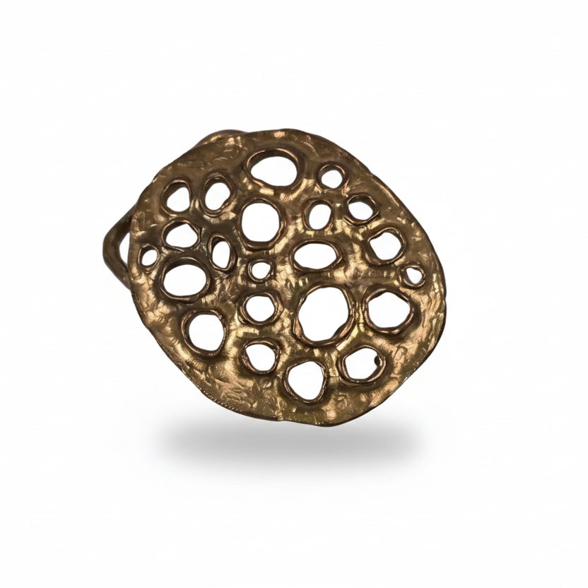 Front view of the Lotus Belt Buckle by Shaya Durbin highlighting the irregular perforated bronze surface and distinctive handcrafted sculptural design.
