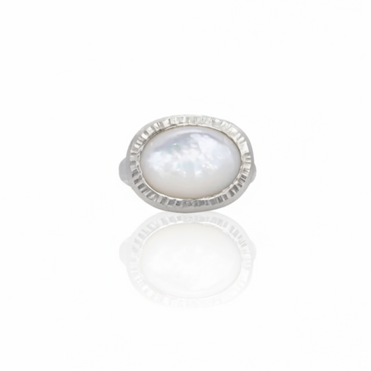 Wide Mother of Pearl Ever Ring by Shaya Durbin featuring an oval iridescent mother-of-pearl gemstone set horizontally in a fluted recycled sterling silver bezel.