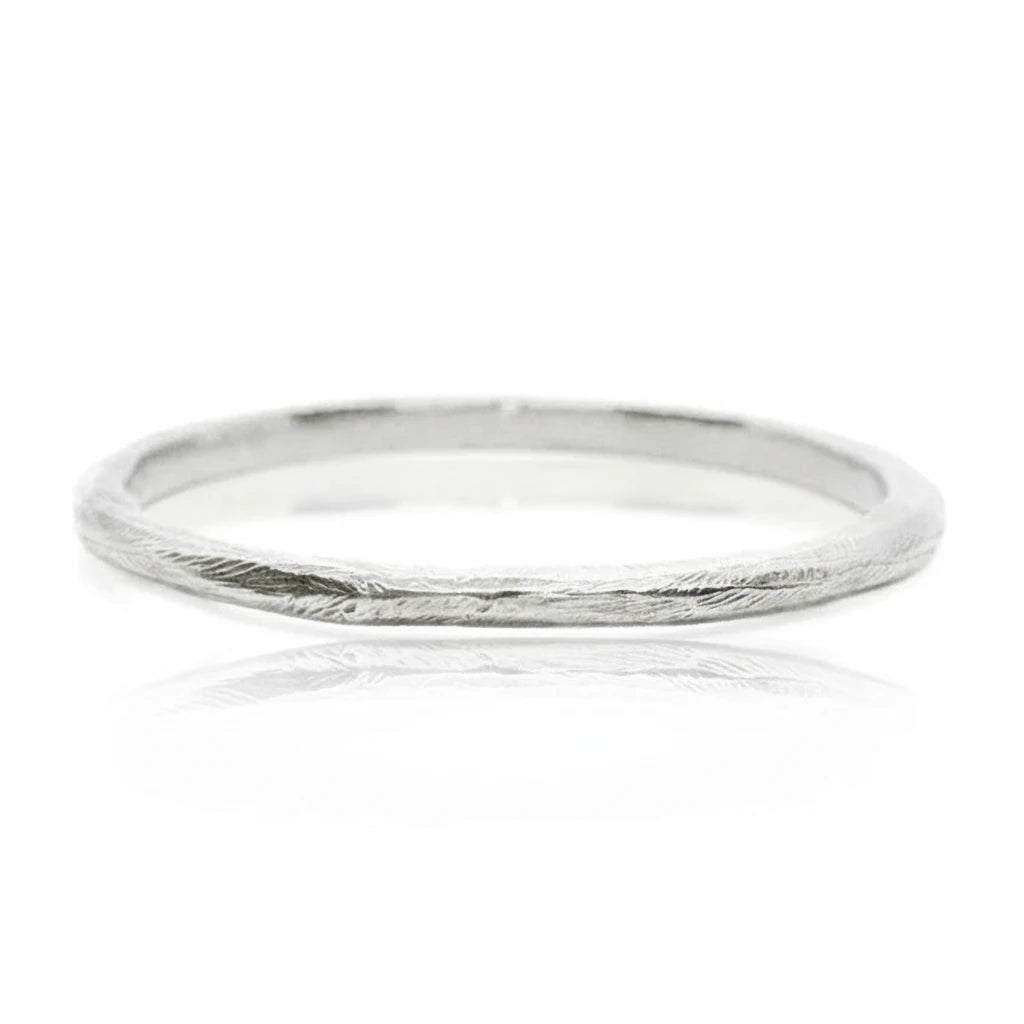 Side view of the sterling silver Reyes Bangle Bracelet, highlighting its slim profile and handcrafted textured finish.