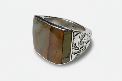 Silver-tone signet ring featuring a rectangular brown stone inlay and engraved decorative details along the sides of the band.