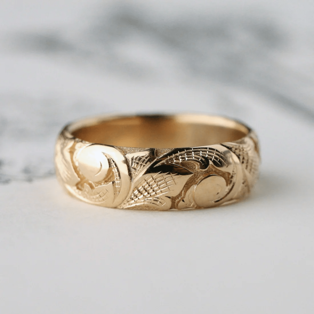 Slim 14k gold acanthus band with hand-engraved scrolls and leaves – front view.