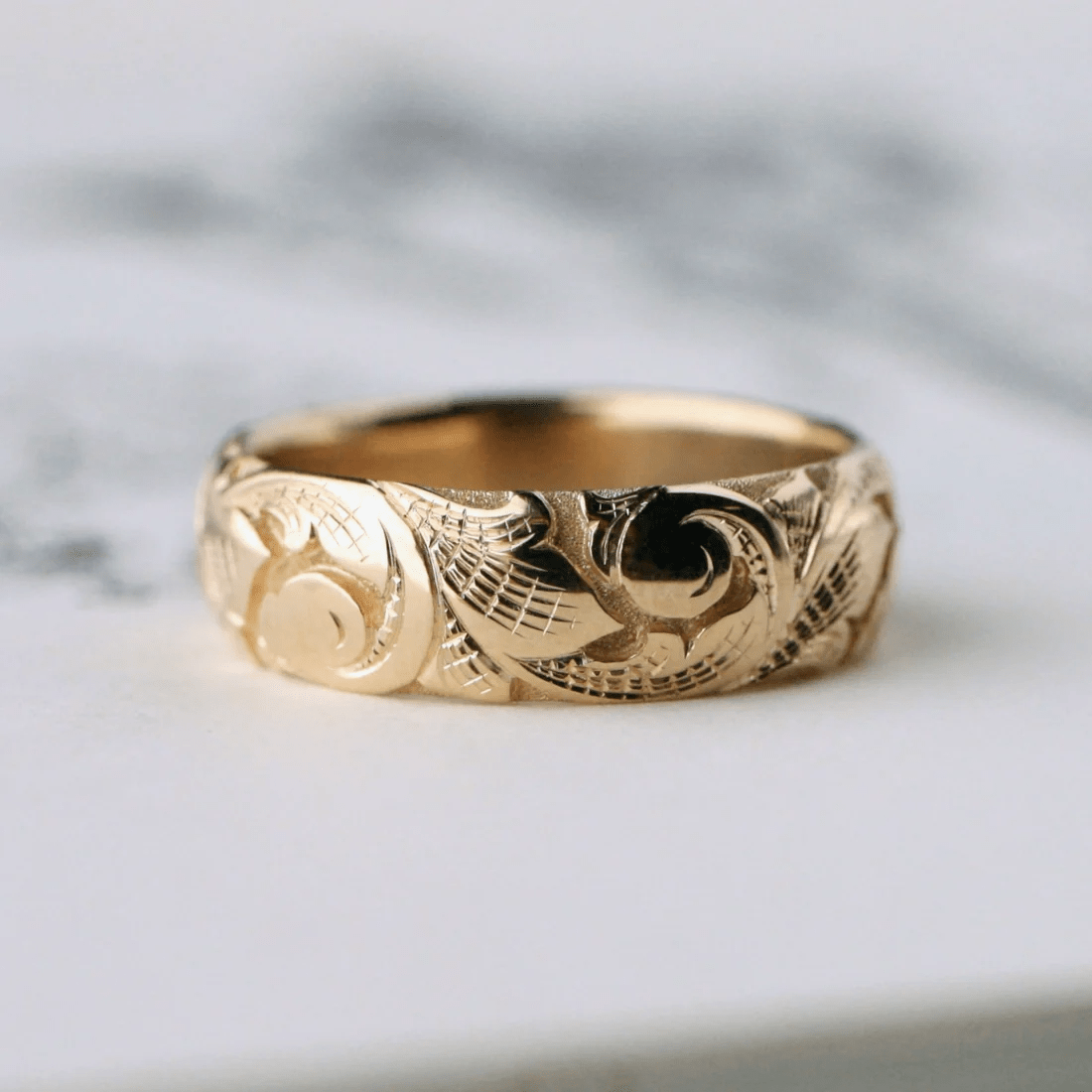 14k gold slim acanthus band ring shown from the front – engraved scroll and leaf details.