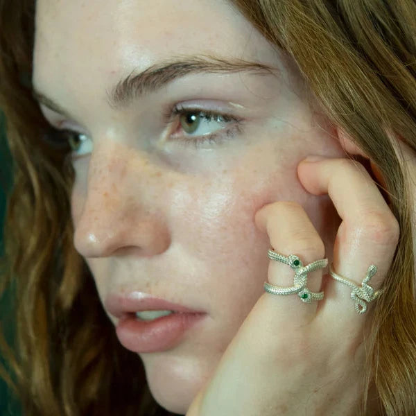 Model wearing the Snake Guardian Ring by Michaela Farkasovska, featuring a sculptural sterling silver serpent with a green Zambian emerald.