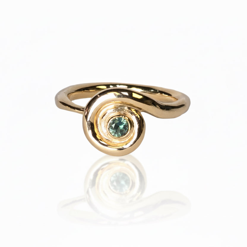 14k yellow gold Spiral Sapphire Ring by Adeline Jewelry featuring a round teal sapphire in a sculptural spiral setting with a flowing gold band.