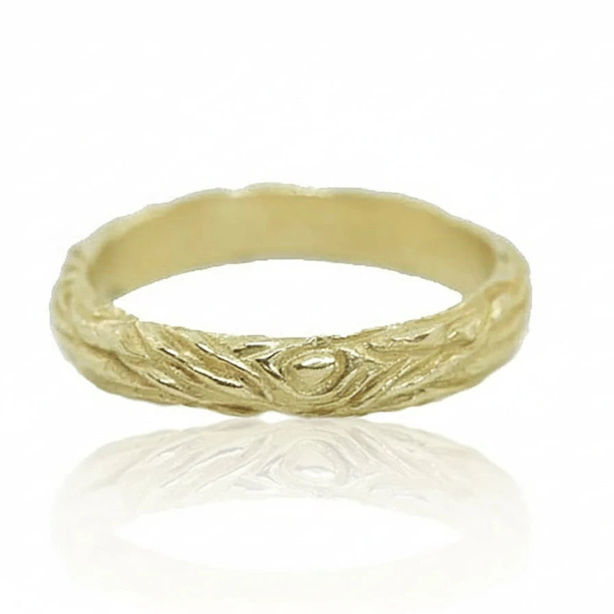 Angled view of the handcrafted 14k yellow gold Sprig Ring, showcasing its slender band, organic branch-inspired carving, and textured surface.